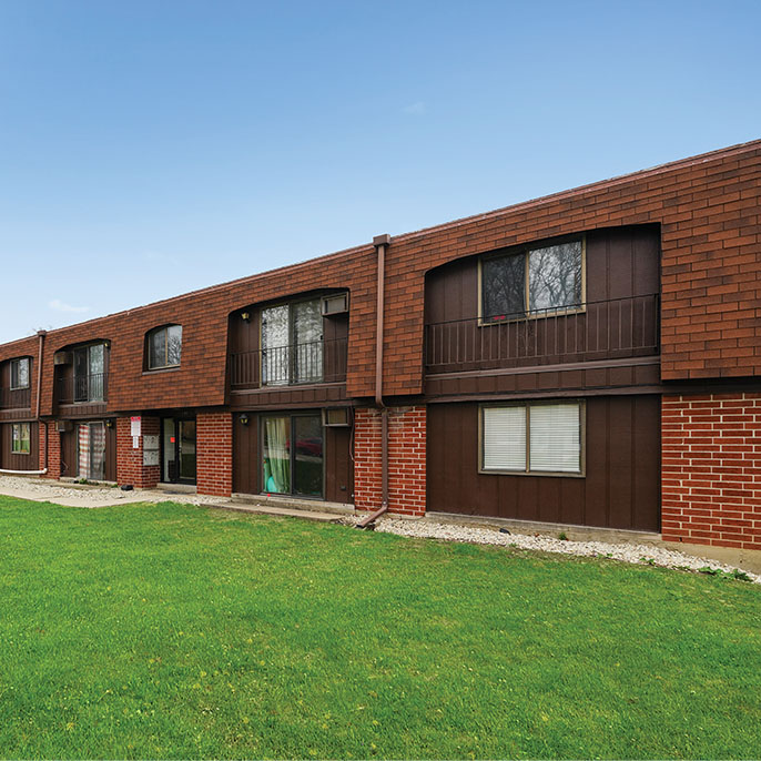 Exterior view of renovated apartment buildings sold in Villa Park multifamily suburban sale.
